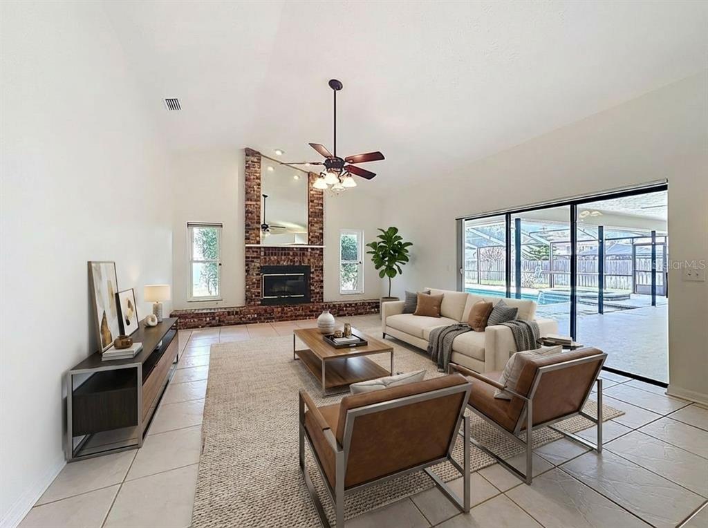 2414 Buckhorn Run Drive Valrico, FL 33596 - Photo 20 of 50 a living room with furniture a fireplace and a flat screen tv