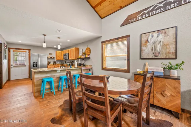 a kitchen with stainless steel appliances granite countertop a sink refrigerator stove and microwave