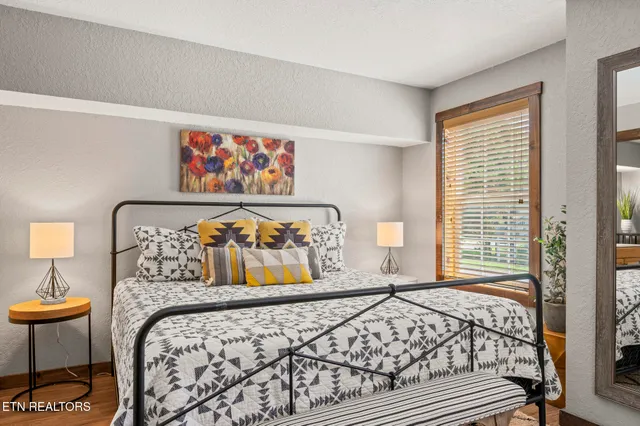 a bed sitting in a bedroom next to a window