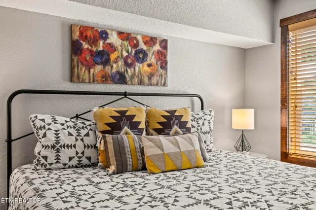 a bedroom with a bed and a window