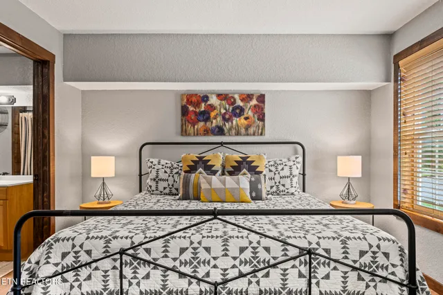 a bedroom with a large bed and a window