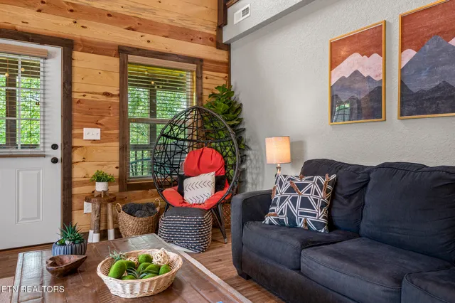 a living room with furniture and a potted plant