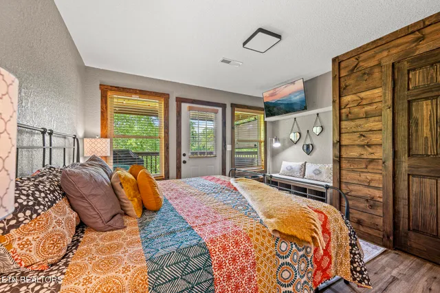 a bedroom with a bed and wooden floor