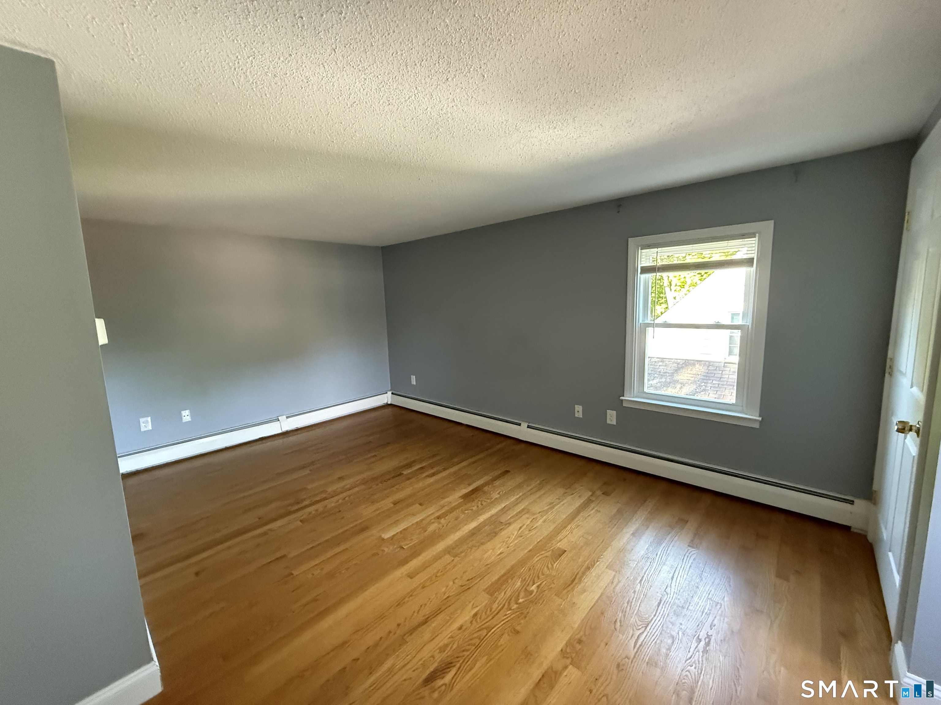 808 East Main Street Torrington, CT 06790 - Photo 32 of 40 an empty room with wooden floor and windows