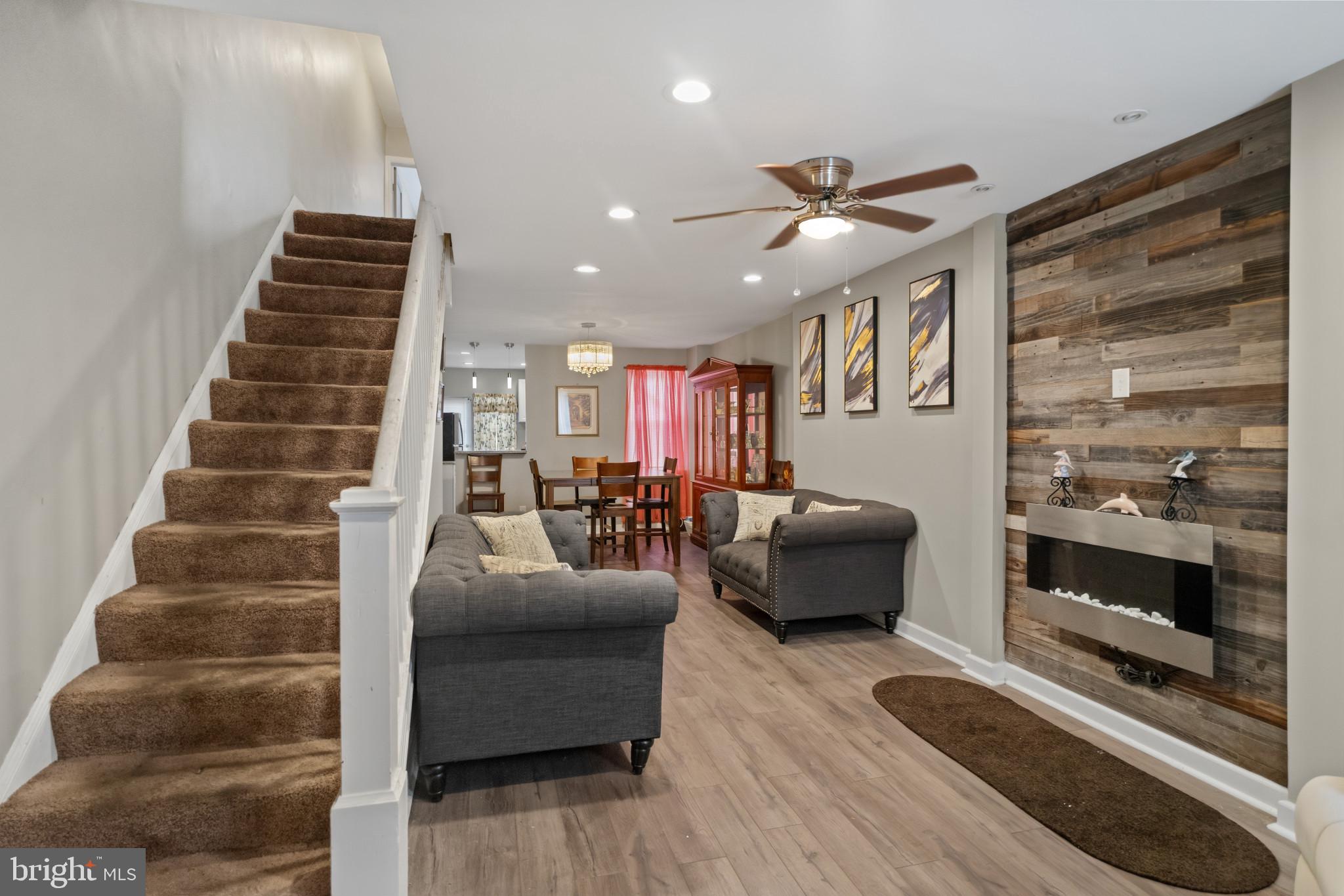 a living room with furniture and a ceiling fan