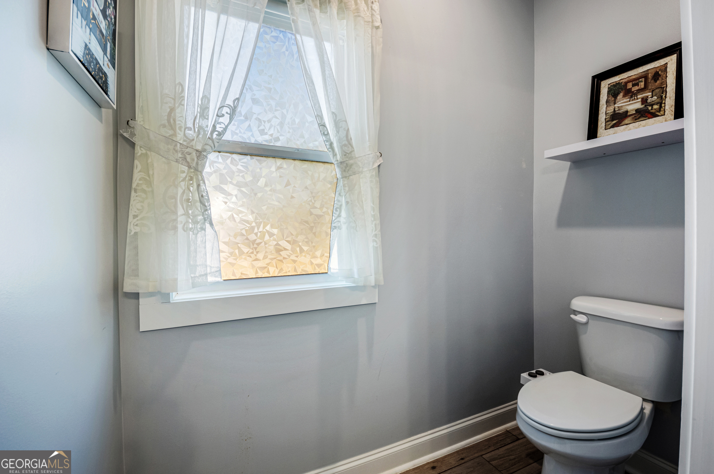 2736 Jones Holly Road Good Hope, GA 30641 - Photo 29 of 49 a white toilet sitting next to a window in a bathroom