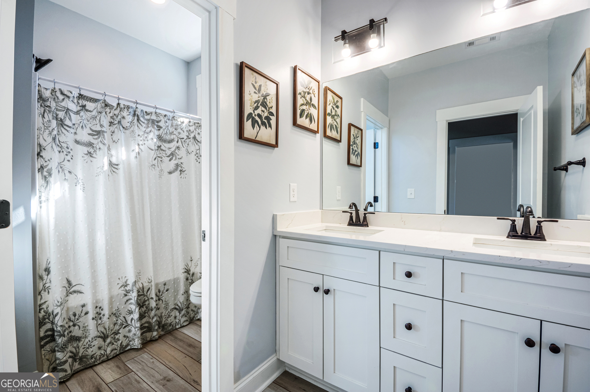 2736 Jones Holly Road Good Hope, GA 30641 - Photo 34 of 49 a bathroom with a double vanity sink and a mirror