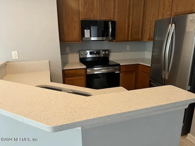 a kitchen with a refrigerator stove and microwave