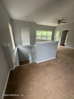 a view of a room with windows and chandelier