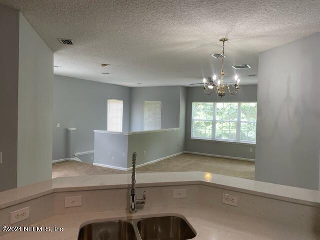 12301 Kernan Forest Boulevard, Unit 302 Jacksonville, FL 32225 - Photo 8 of 14 a view of a room with windows and chandelier