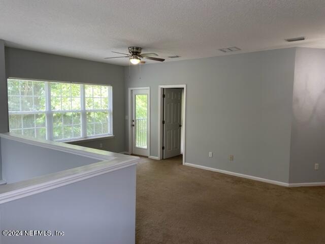 12301 Kernan Forest Boulevard, Unit 302 Jacksonville, FL 32225 - Photo 10 of 14 an empty room with windows and ceiling fan