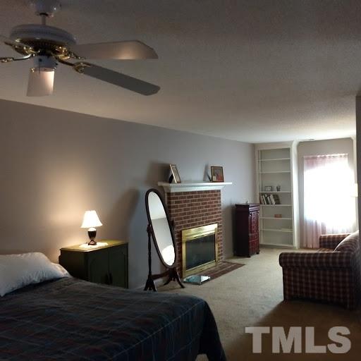4404 Liverpool Lane Raleigh, NC 27604 - Photo 14 of 18 a bedroom with a bed and wooden floor