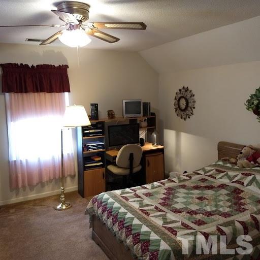 4404 Liverpool Lane Raleigh, NC 27604 - Photo 15 of 18 a bedroom with a bed and a chandelier