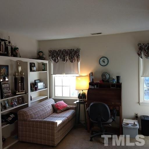 4404 Liverpool Lane Raleigh, NC 27604 - Photo 16 of 18 a living room with furniture and a window