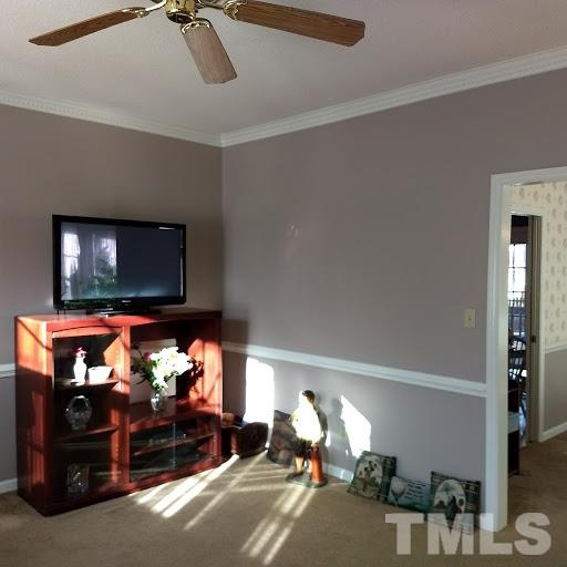 4404 Liverpool Lane Raleigh, NC 27604 - Photo 4 of 18 a living room with furniture a flat screen tv and a fireplace