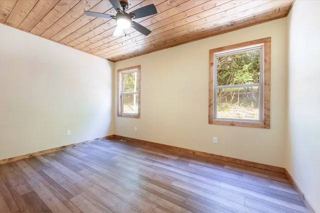 an empty room with wooden floor and closet