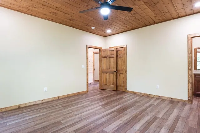 a view of an empty room with wooden floor
