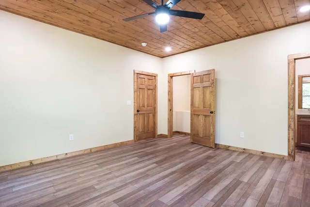 a white toilet sitting next to a white wall