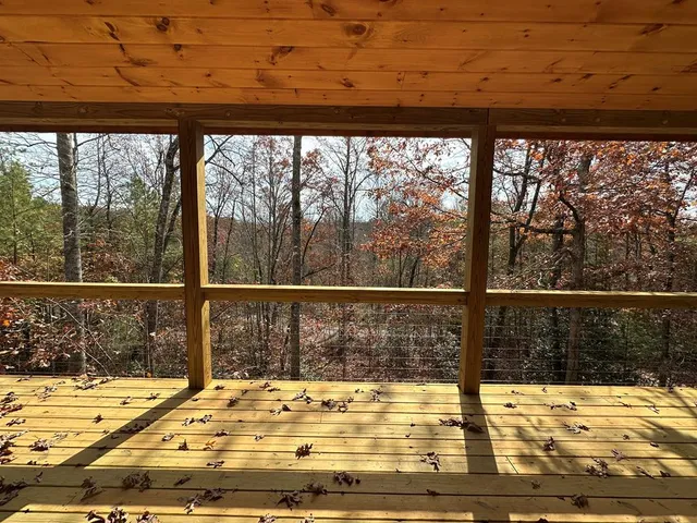 a view of a balcony with wooden floor