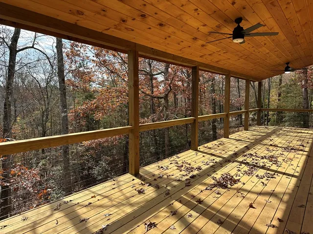 a view of a balcony with wooden floor