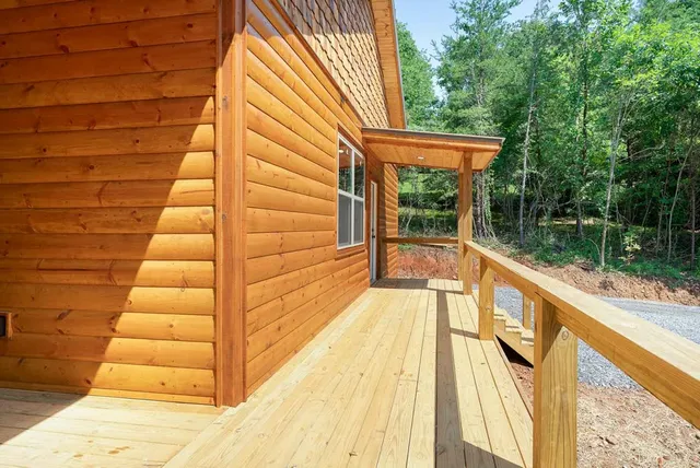 a view of a balcony with wooden floor and fence