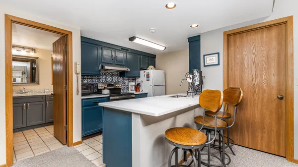 a kitchen that has a table and chairs in it