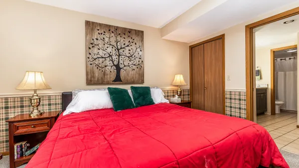 a bed sitting in a bedroom next to a window