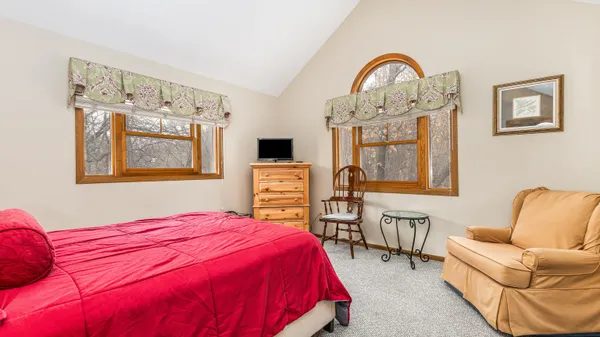 a bedroom with a bed a couch and dresser