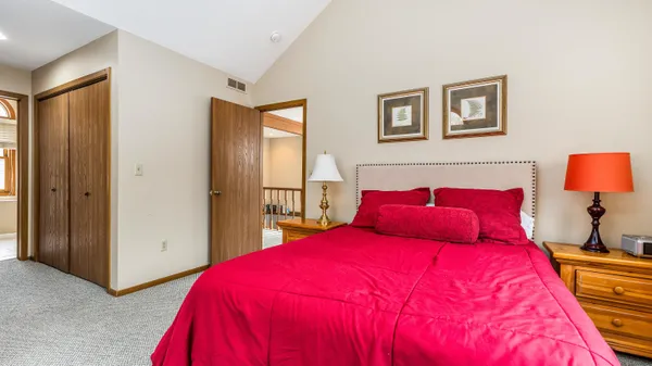 a bedroom with a bed and a lamp