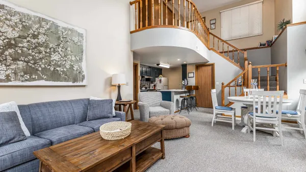 a living room with furniture and a chandelier