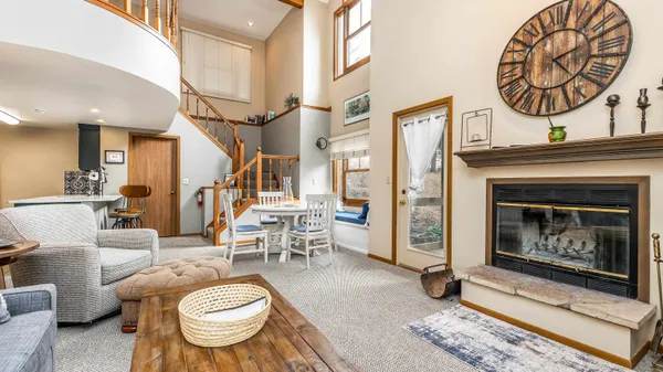 a living room with furniture a fireplace and a table