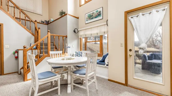 a dining room with wooden floor and furniture