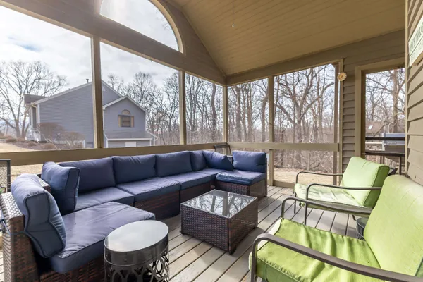 a living room with furniture and a floor to ceiling window