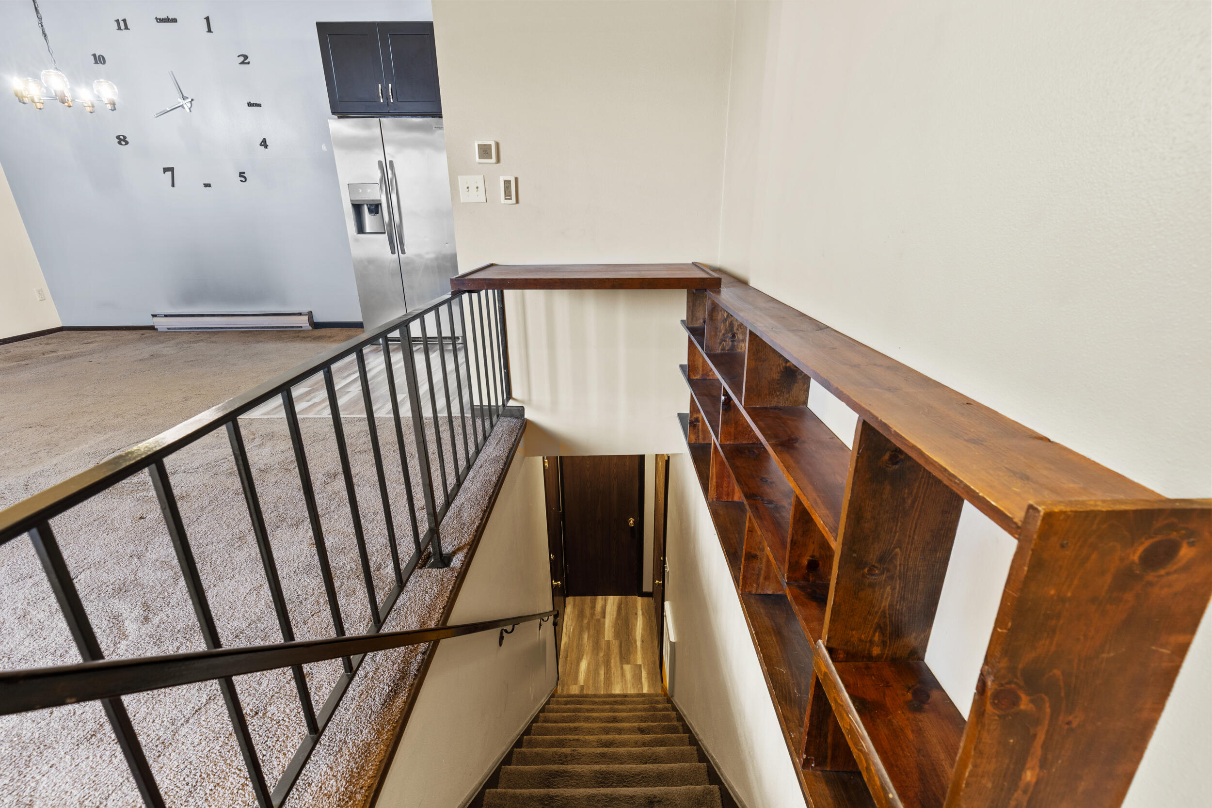 6980 North Raintree Court, Unit D Milwaukee, WI 53223 - Photo 13 of 16 Stairs into living room
