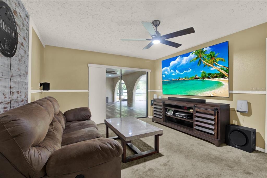 7487 River Country Drive Weeki Wachee, FL 34607 - Photo 39 of 53 a living room with furniture and a flat screen tv