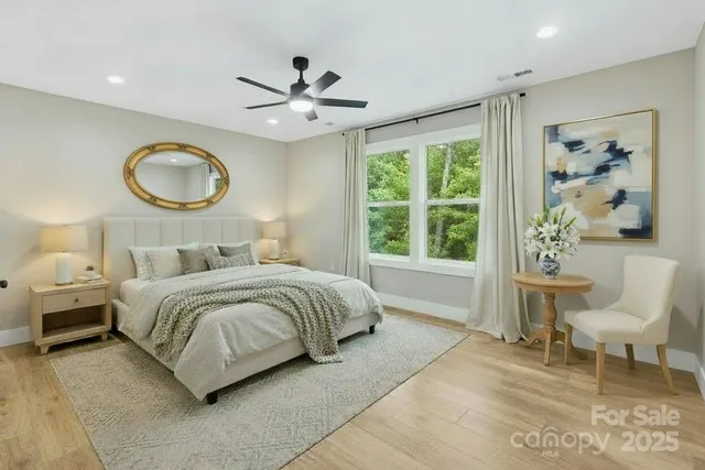 a bedroom with a bed mirror and window