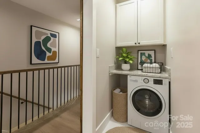 a view of a hallway with washer and dryer