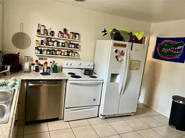 a kitchen with a refrigerator and a stove