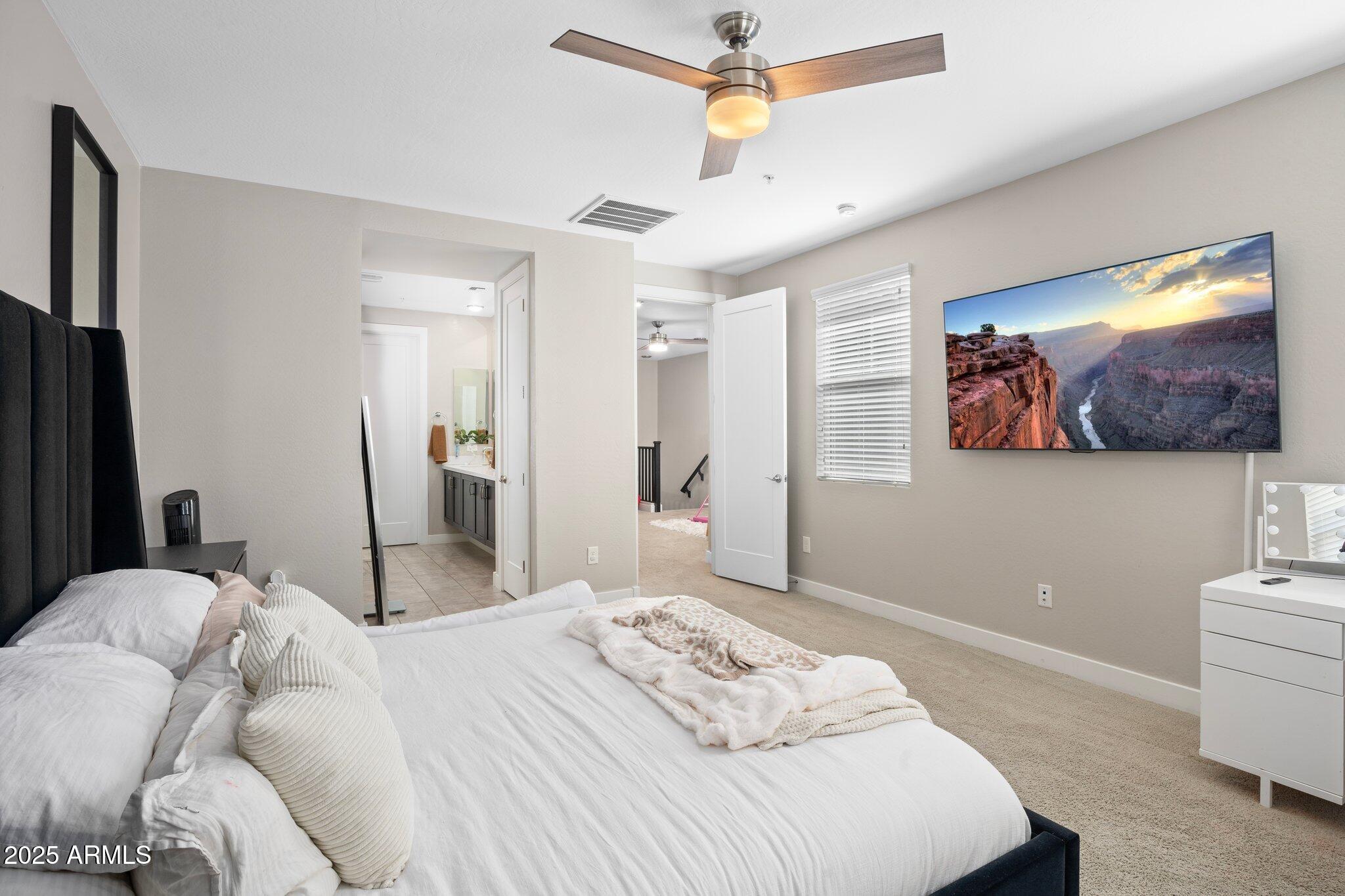 3855 South McQueen Road, Unit 21 Chandler, AZ 85286 - Photo 14 of 35 a bedroom with a bed and a flat screen tv
