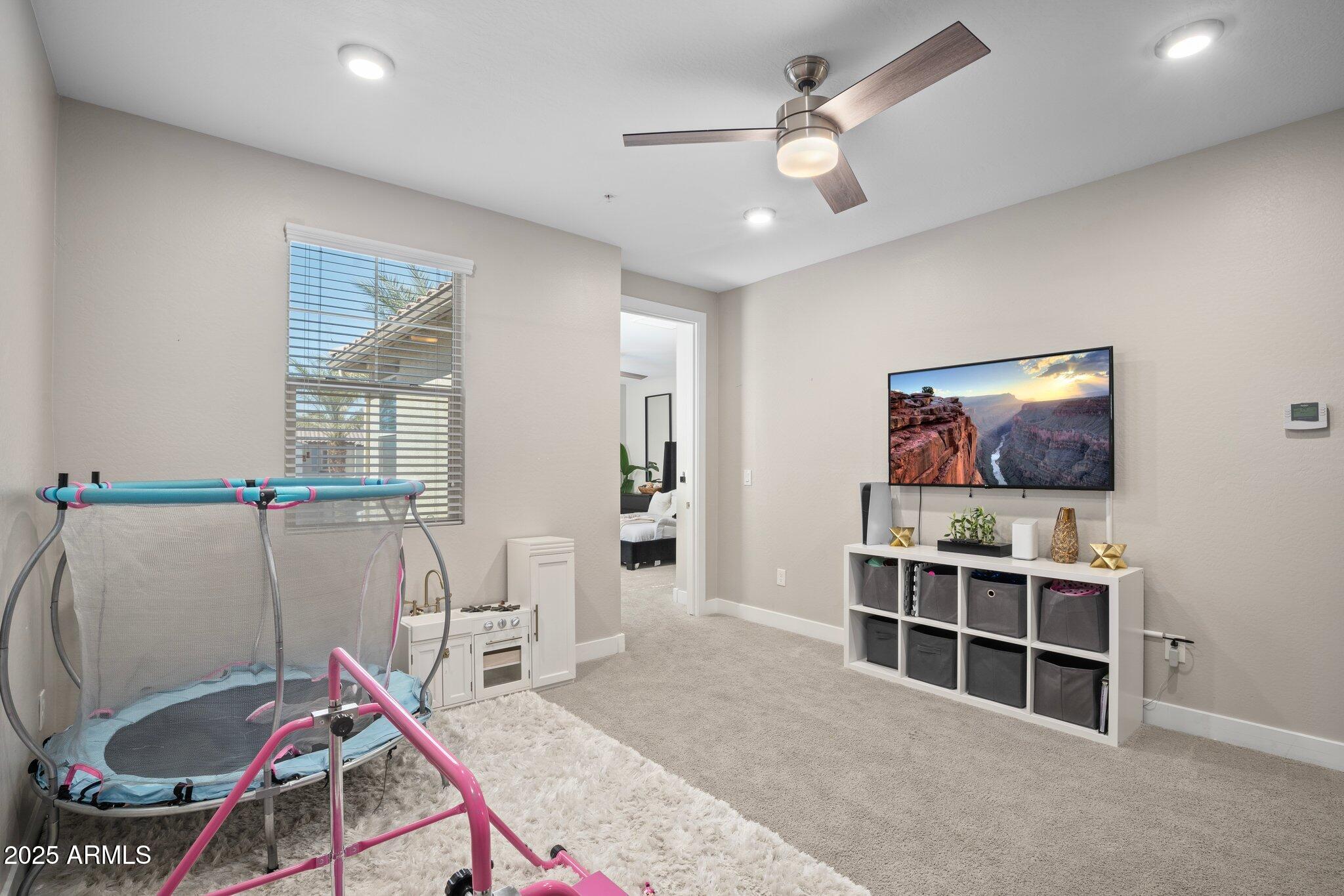 3855 South McQueen Road, Unit 21 Chandler, AZ 85286 - Photo 20 of 35 a living room with furniture a flat screen tv and a chandelier
