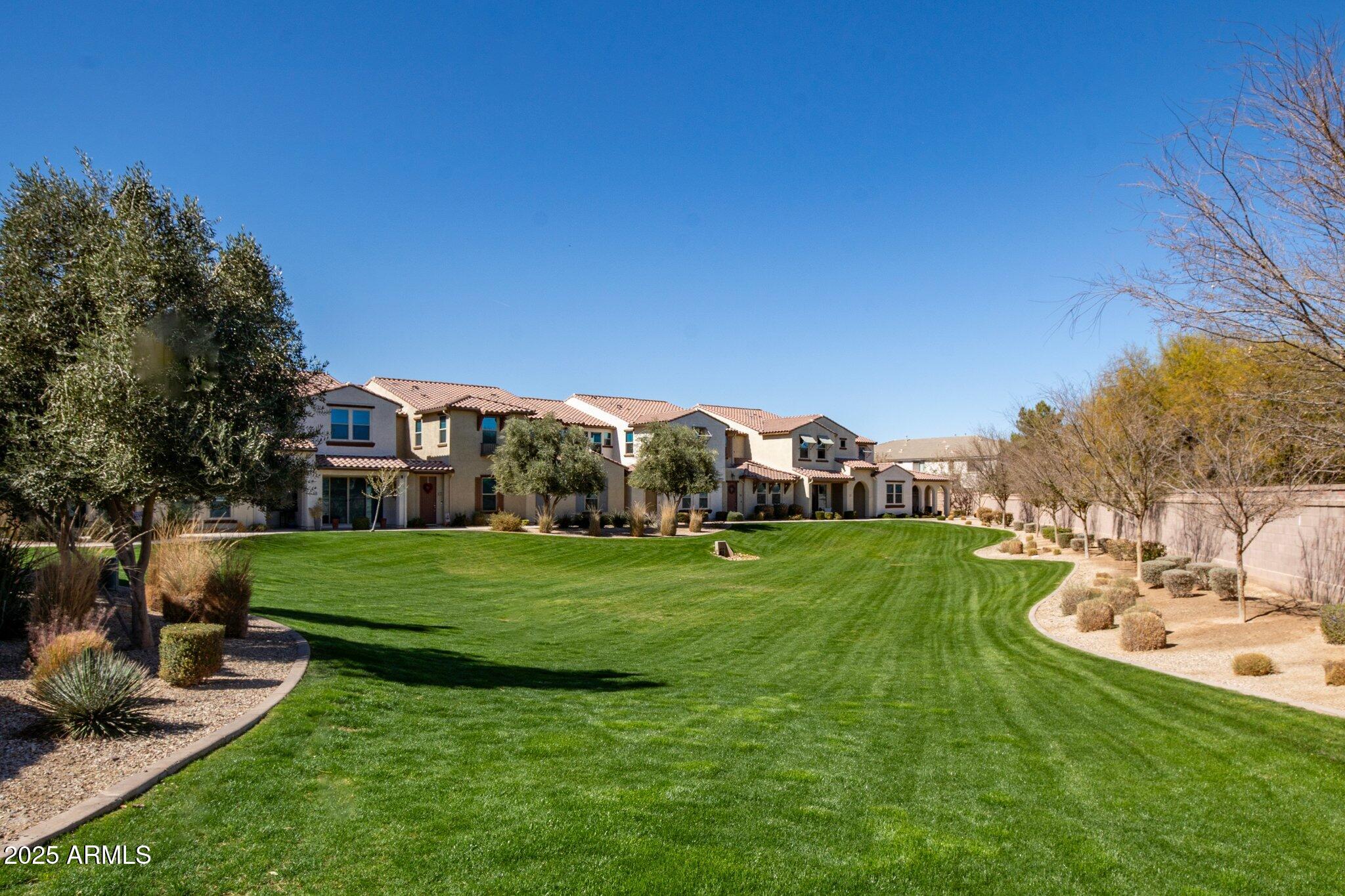 3855 South McQueen Road, Unit 21 Chandler, AZ 85286 - Photo 26 of 35 a front view of a house with garden