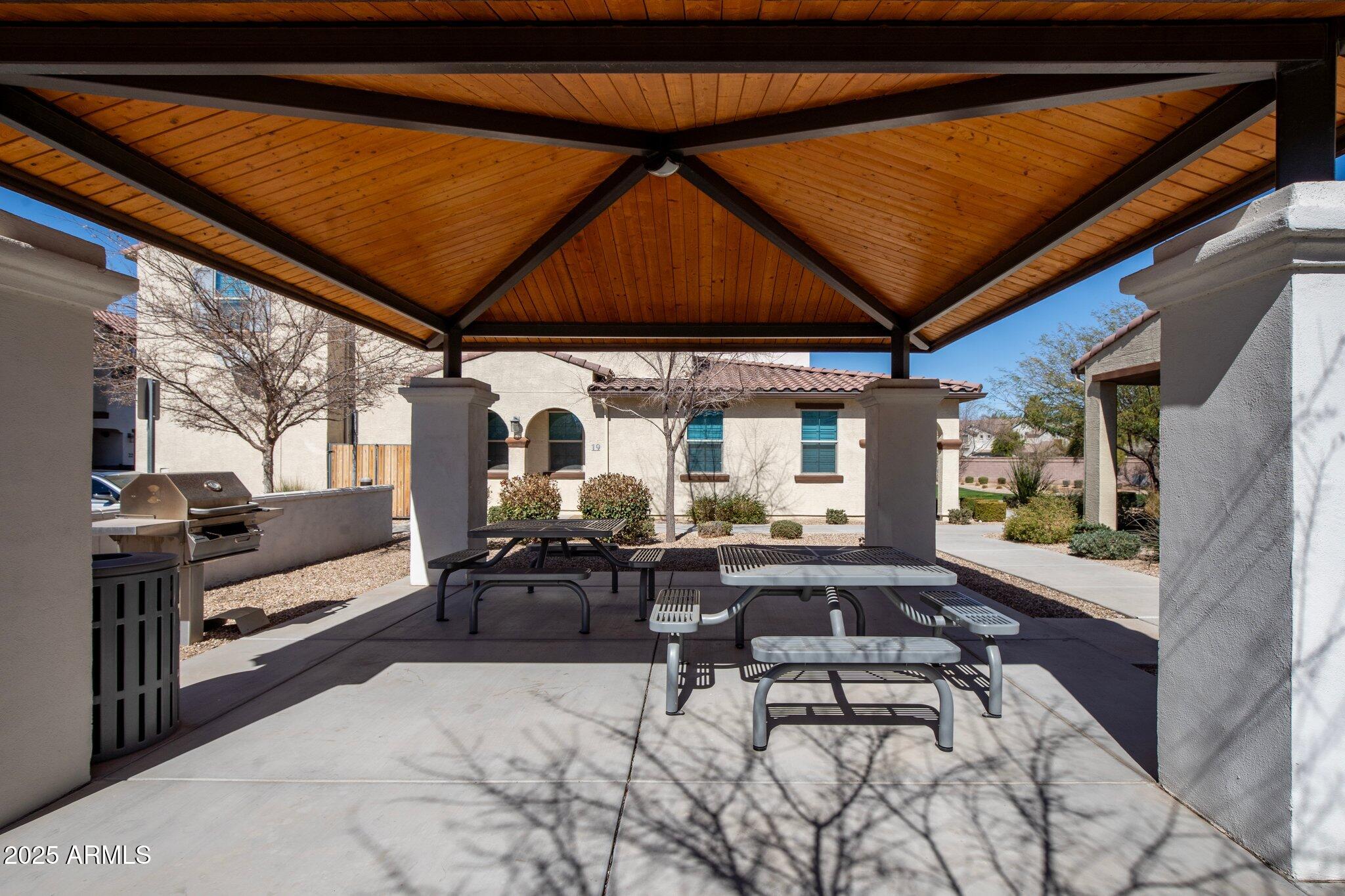 3855 South McQueen Road, Unit 21 Chandler, AZ 85286 - Photo 30 of 35 a view of a patio with table and chairs under an umbrella