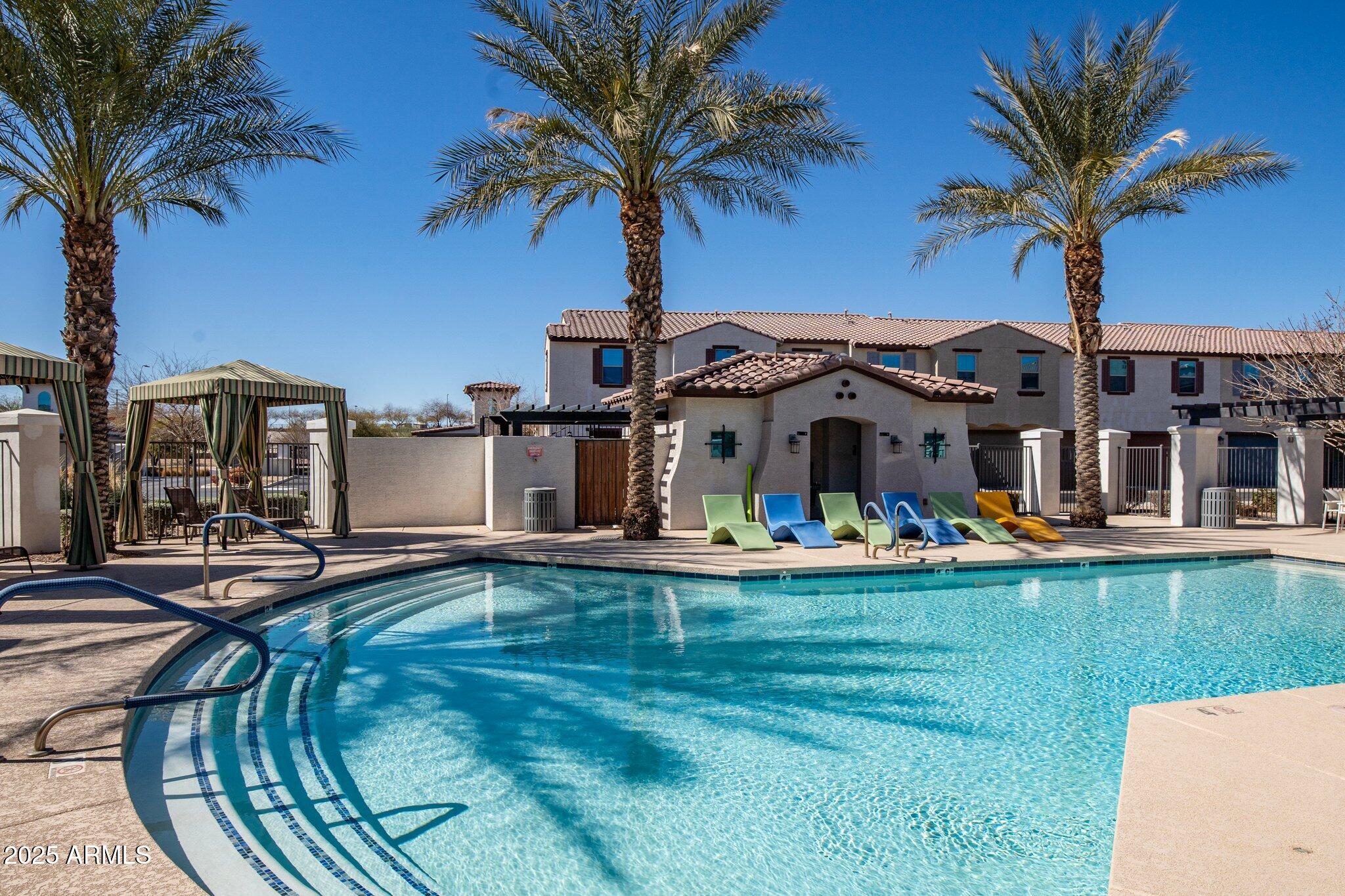 3855 South McQueen Road, Unit 21 Chandler, AZ 85286 - Photo 34 of 35 a front view of house with yard and swimming pool
