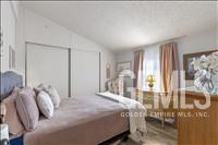 Undisclosed Address Tehachapi, CA 93561 - Photo 13 of 28 a bedroom with a bed and a large window