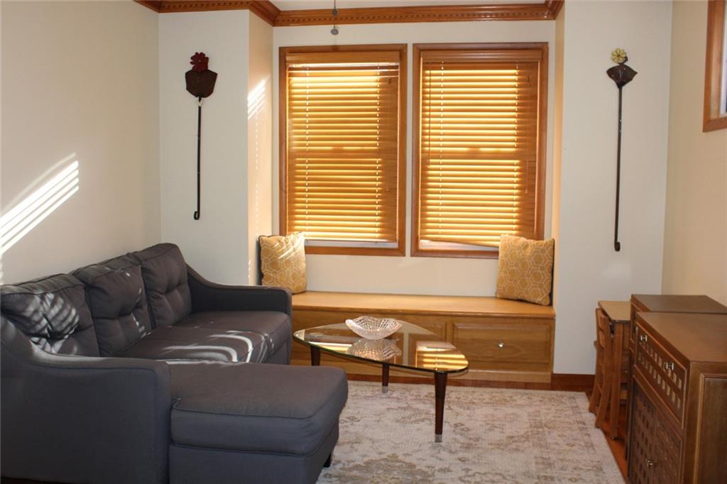 184 Richbarn Road Pittsburgh, PA 15212 - Photo 7 of 16 Enjoy the first floor family room with hardwood floors, crown molding, stained glass windows and a large window seat.