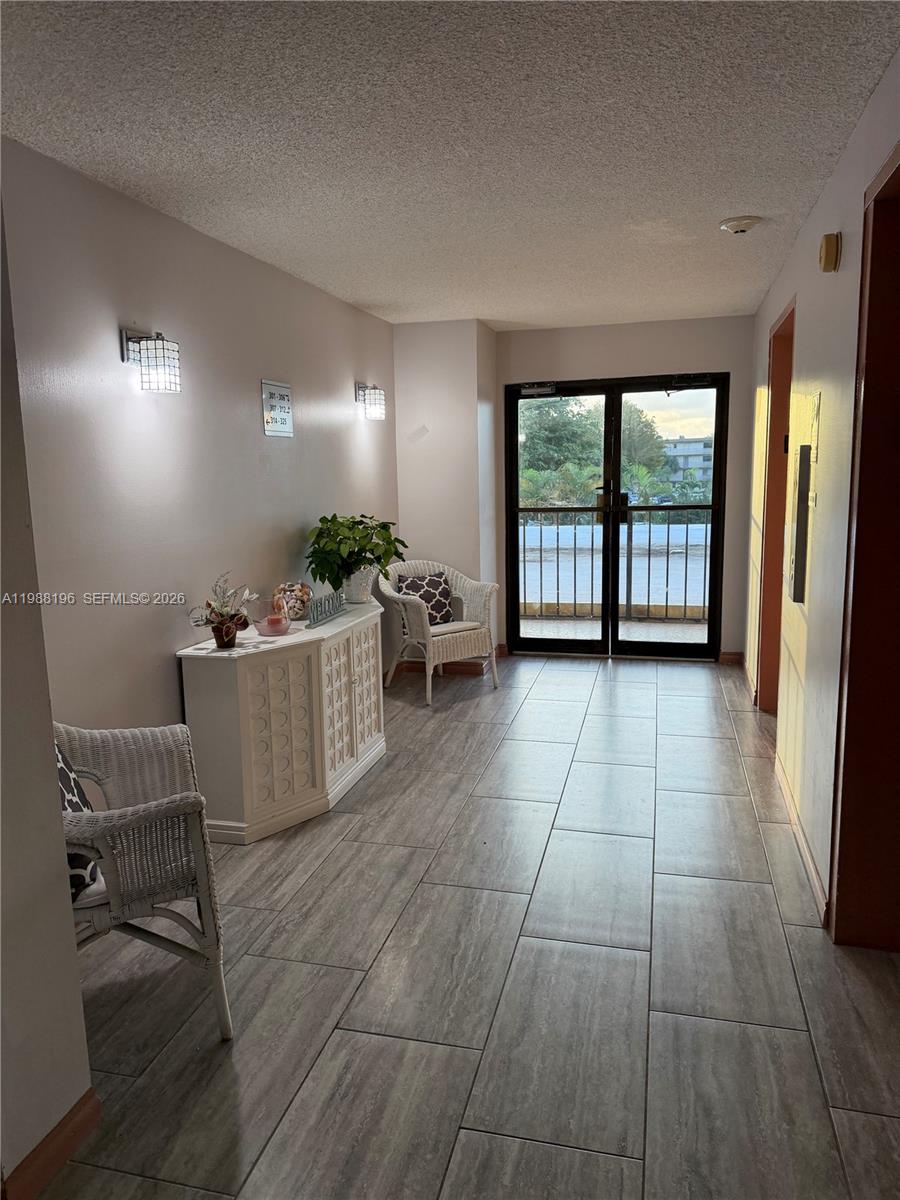 9355 Southwest 8th Street, Unit 305 Boca Raton, FL 33428 - Photo 11 of 12 a living room with furniture and large windows