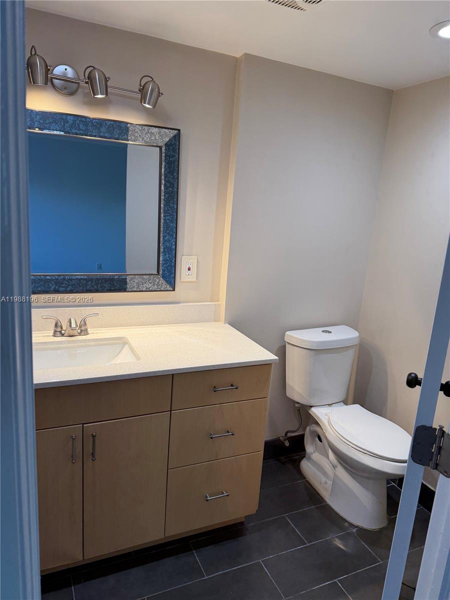 9355 Southwest 8th Street, Unit 305 Boca Raton, FL 33428 - Photo 2 of 12 a bathroom with a sink toilet and vanity