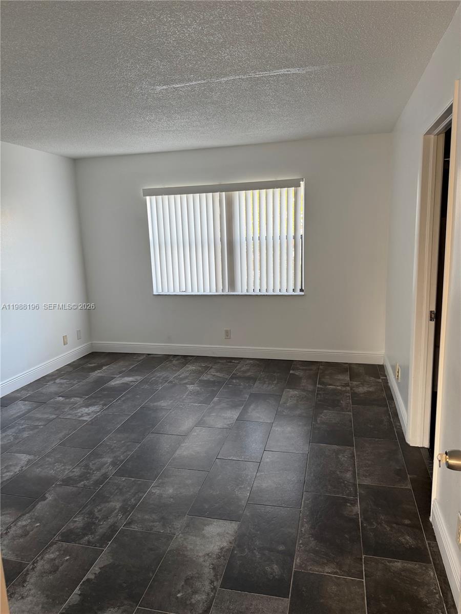 9355 Southwest 8th Street, Unit 305 Boca Raton, FL 33428 - Photo 3 of 12 a view of an empty room and window