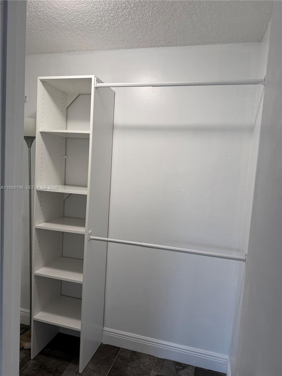 9355 Southwest 8th Street, Unit 305 Boca Raton, FL 33428 - Photo 4 of 12 a view of an empty walk in closet