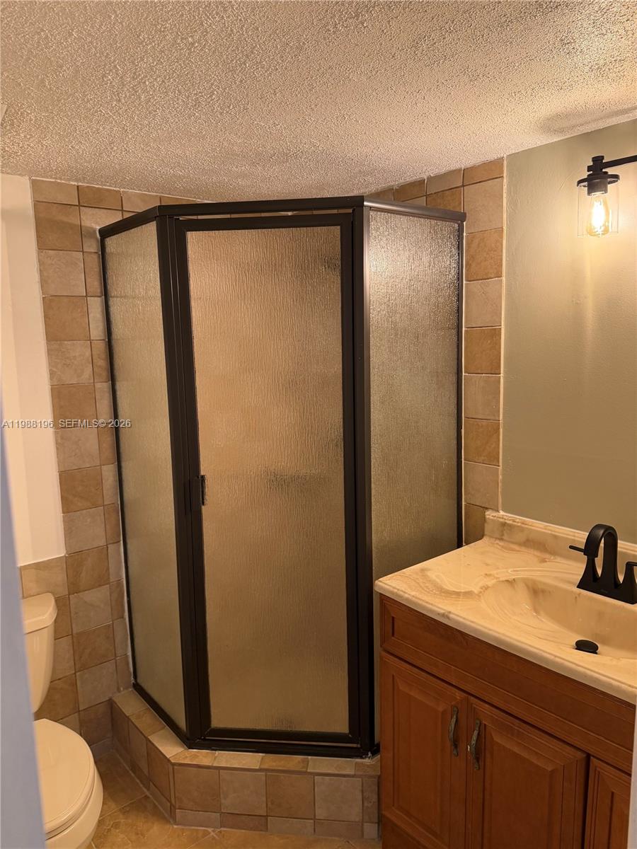 9355 Southwest 8th Street, Unit 305 Boca Raton, FL 33428 - Photo 5 of 12 a bathroom with a shower and a sink